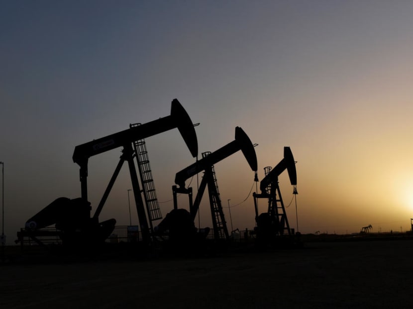 Pump jacks operate at sunset in Midland, Texas, United States.