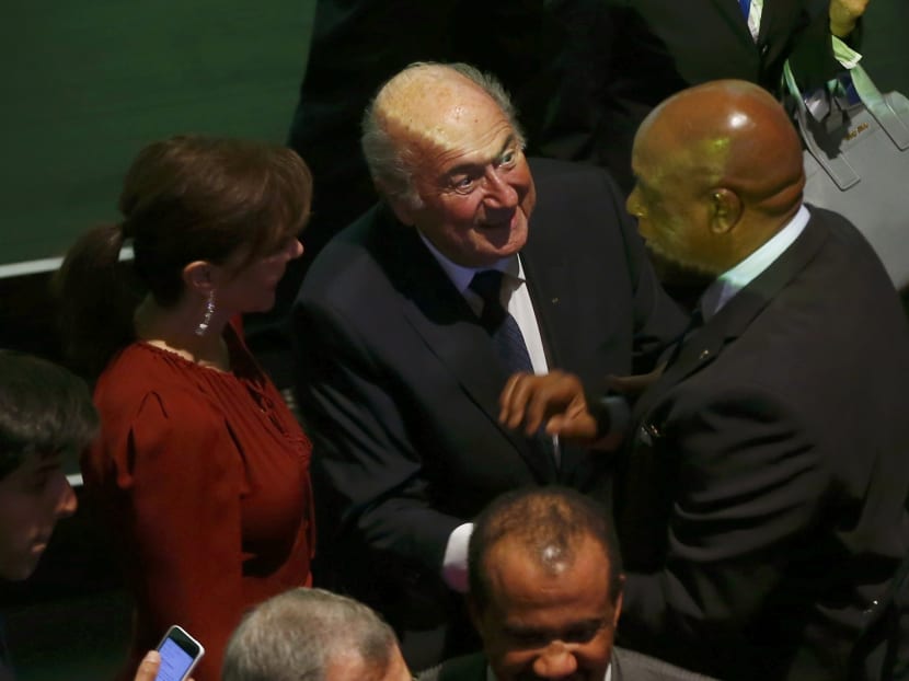 FIFA President Sepp Blatter (2nd L) greet a delegate after the opening ceremony of the 65th FIFA Congress in Zurich, Switzerland, May 28, 2015. Photo: Reuters