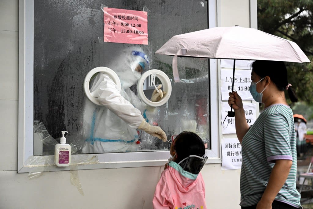 A health worker takes a swab sample from a child to be tested for the Covid-19 coronavirus at a nucleic acid testing station in Beijing on June 22, 2022.
A health worker takes a swab sample from a child to be tested for the Covid-19 coronavirus at a nucleic acid testing station in Beijing on June 22, 2022.