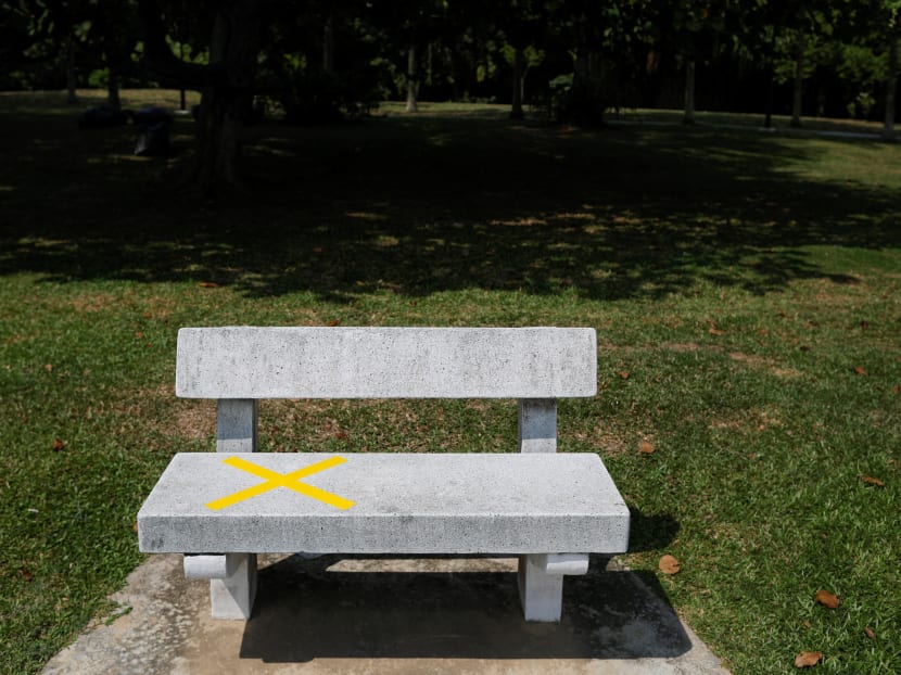 A bench marked out with tape to encourage physical distancing is pictured at a park in Singapore on April 1, 2020.