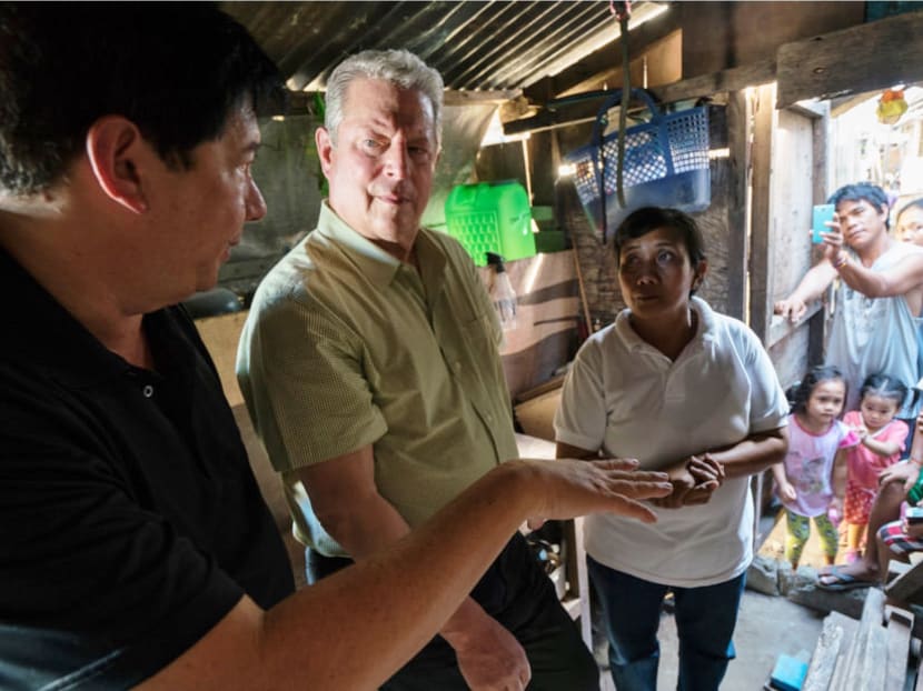 Al Gore (second from left) talks to villagers in this movie still from An Inconvenient  Sequel: Truth To Power.