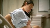 woman going through pain during contractions before giving birth