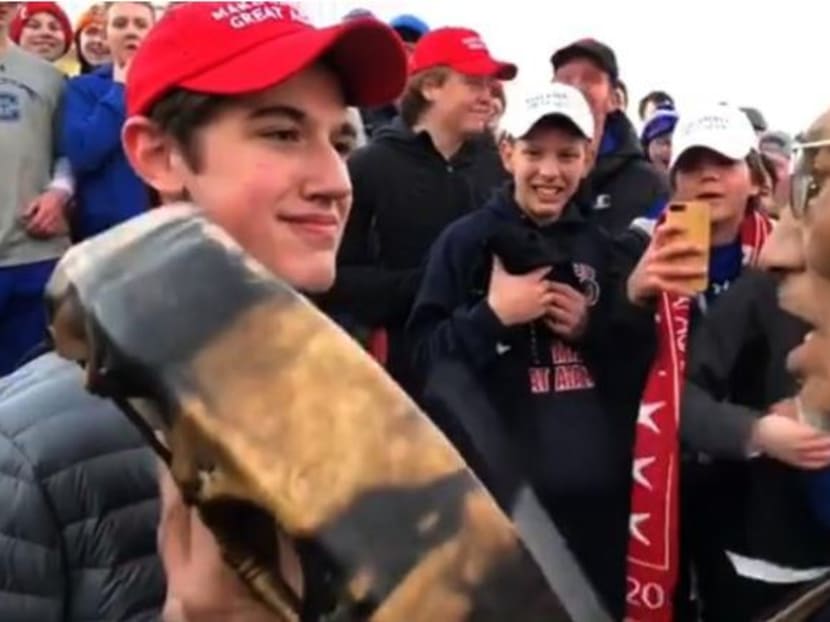 Nick Sandmann, a student from the private, all-male Covington Catholic High School in northern Kentucky, is seen in the video standing face to face with the Indian activist, Nathan Phillips, staring at him with a smile, while Mr Phillips sings and plays a drum.