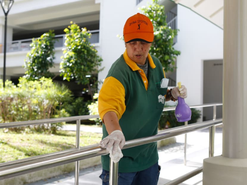 A cleaner demonstrates the enhanced cleaning and sanitation procedures undertaken by Tampines Town Council on Feb 5, 2020.