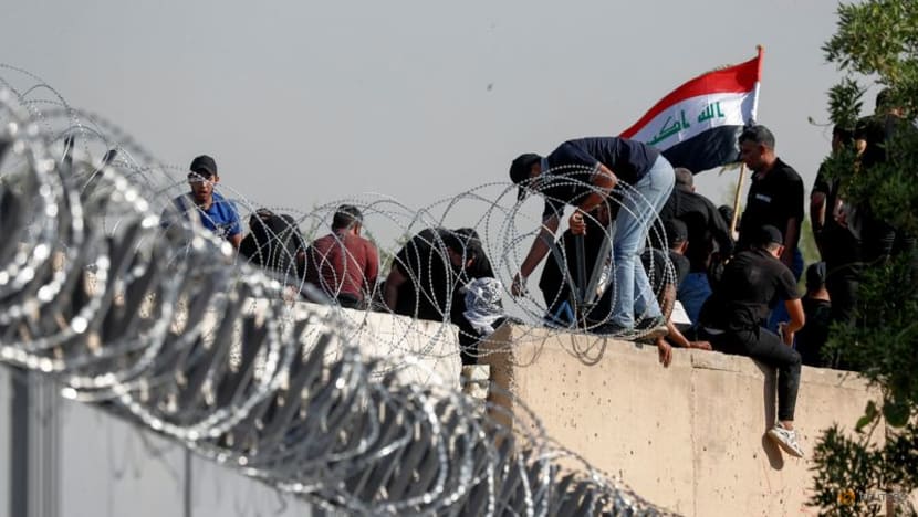 Clashes kill 10 as Iraq's Sadr quits politics, loyalists storm complex