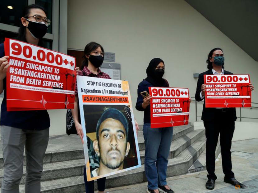 FILE PHOTO: Activists hold placards and a poster against the imminent execution of Nagaenthran Dharmalingam, who was sentenced to death for drug trafficking in Singapore, outside the Singapore High Commission in Kuala Lumpur, Malaysia November 23, 2021. REUTERS/Lai Seng Sin/File Photo