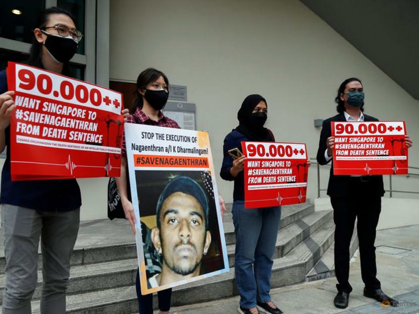FILE PHOTO: Activists hold placards and a poster against the imminent execution of Nagaenthran Dharmalingam, who was sentenced to death for drug trafficking in Singapore, outside the Singapore High Commission in Kuala Lumpur, Malaysia November 23, 2021. REUTERS/Lai Seng Sin/File Photo FILE PHOTO: Activists hold placards and a poster against the imminent execution of Nagaenthran Dharmalingam, who was sentenced to death for drug trafficking in Singapore, outside the Singapore High Commission in Kuala Lumpur, Malaysia November 23, 2021. REUTERS/Lai Seng Sin/File Photo