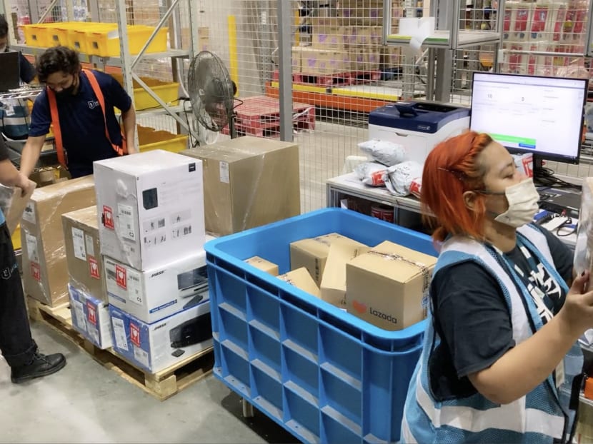 Workers packing and sorting high-valued items such as branded electronics at Lazada's warehouse in Singapore.