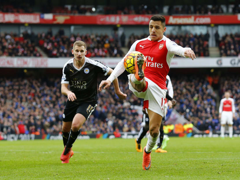 Leicester’s Marc Albrighton (left) in action against Arsenal’s Alexis Sanchez at the Emirates last season, a match the Gunners won 2-1. Sanchez looked unfit last weekend against Liverpool. PHOTOS: REUTERS
