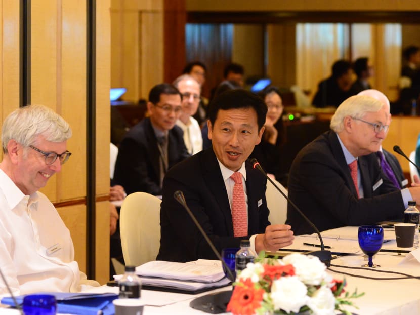 Education Minister Ong Ye Kung (centre) speaking at the IAAP meeting with Prof Stephen Toope (left) and Mr Peter Voser.