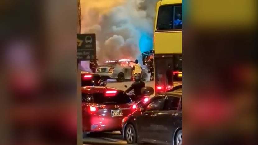 Car engulfed in flames at Tampines junction Car engulfed in flames at Tampines junction