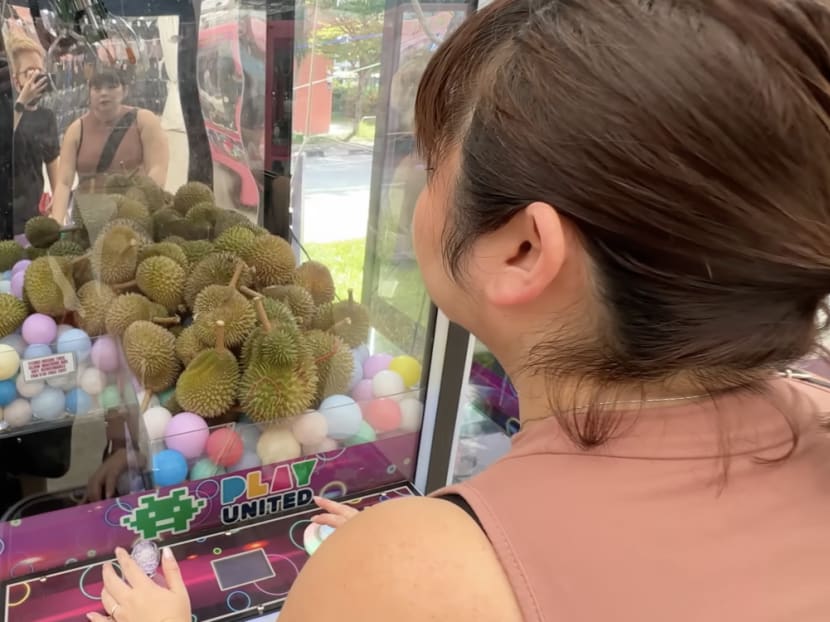 Netizens take a jab at durian claw machines while others are skeptical