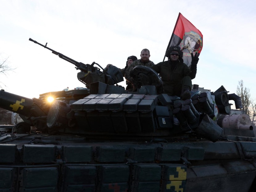 Ukrainian tankists greet people as they ride on a road in Kherson region on Nov 14, 2022, amid Russia's invasion of Ukraine.