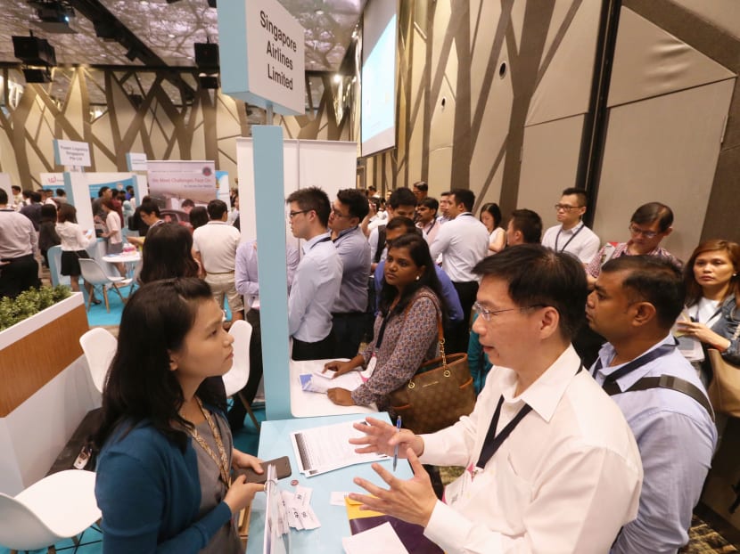 Job seekers making queries at the Adapt And Grow job fair at Crowne Plaza Changi Airport on Feb 8, 2017. Photo: Ooi Boon Keong/TODAY
