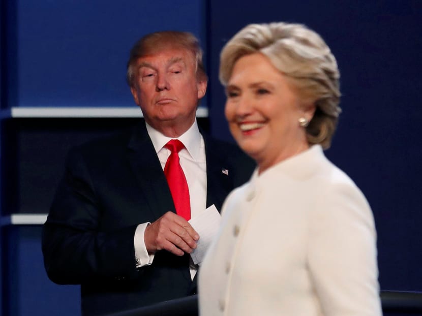 Republican U.S. presidential nominee Donald Trump and Democratic U.S. presidential nominee Hillary Clinton finish their third and final 2016 presidential campaign debate at UNLV in Las Vegas, Nevada. Photo: Reuters