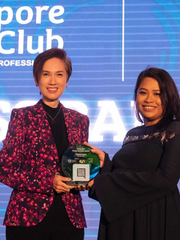 TODAY journalist Nabilah Awang receiving her award from Communications and Information Minister Josephine Teo on June 10, 2022.