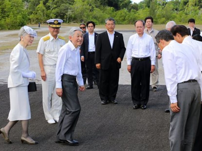 Emperor Akihito, third left, and Empress Michiko, left, arrive on Pelelilu island in Palau Thursday, April 9, 2015. Photo: AP