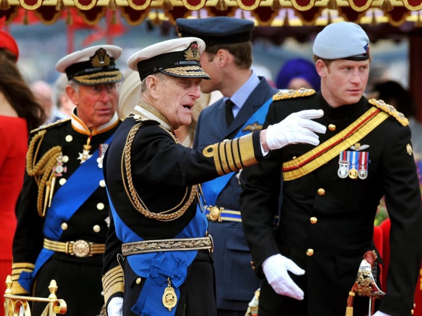 In this file photo taken on June 3, 2012, members of the Royal family (from left to right) Prince Charles, Prince Philip, Prince William and Prince Harry talk onboard the Spirit of Chartwell during the Thames Diamond Jubilee Pageant on the River Thames in London.