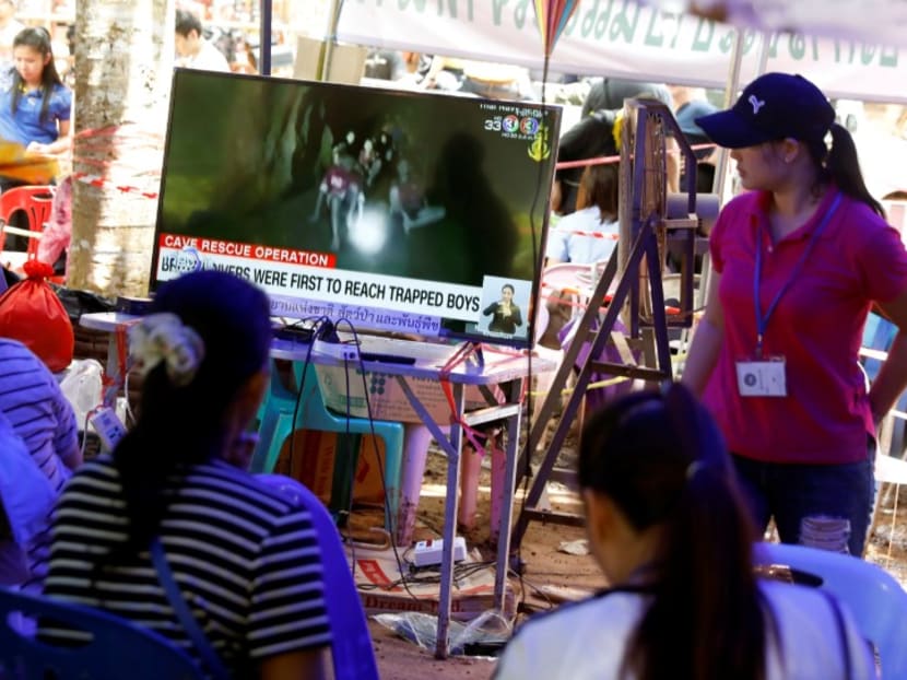 Family members watch a television news broadcast of the trapped members of an under-16 soccer team and their coach, after they were found alive after being trapped in a flooded cave for more than a week,in the northern province of Chiang Rai, Thailand July 4, 2018.