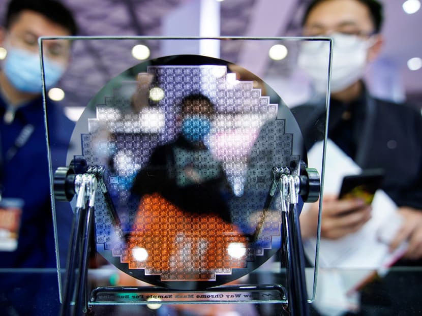 Visitors look at a display of a semiconductor device at Semicon China, a trade fair for semiconductor technology, in Shanghai, China, on March 17, 2021.