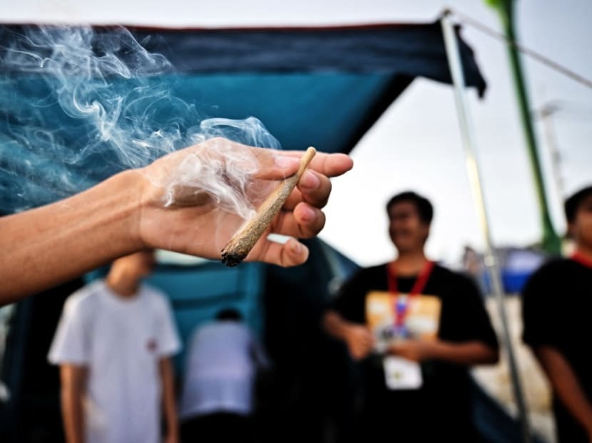People smoke weed to celebrate the legalisation of cannabis at the “Thailand: 420 Legalaew!” weekend festival hosted by Highland in Nakhon Pathom province on June 11, 2022.