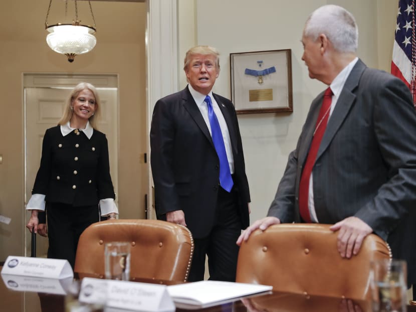 President Donald Trump, followed by Counselor to the President Kellyanne Conway, left, walks into the Roosevelt Room of the White House in Washington, Wednesday, Feb. 1, 2017, as David O'Steen of the National Right to Life watches. Photo: AP