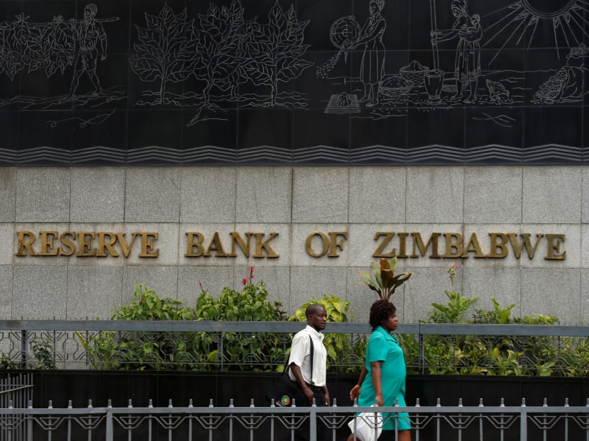 People walk past the Reserve Bank of Zimbabwe building in Harare, Zimbabwe on Feb 25, 2019.