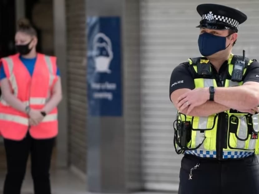 A police officer wears a face mask as he stands on the concourse at Waterloo Station in London on Jun 15, 2020. 
