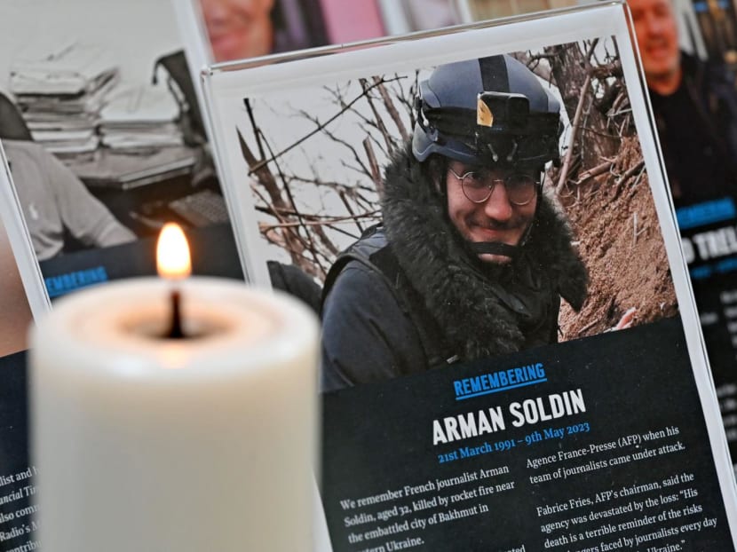 A tribute to AFP video journalist Arman Soldin is pictured among tributes to other journalists, at St Bride's Church in central London on May 10, 2023