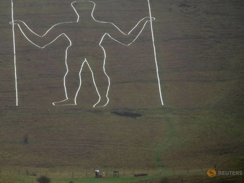 COVID face mask painted on giant English chalk figure COVID face mask painted on giant English chalk figure