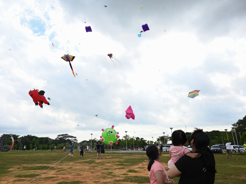 A family watching people flying kites at the open field at Marina Barrage in Singapore on Dec 27, 2020.
