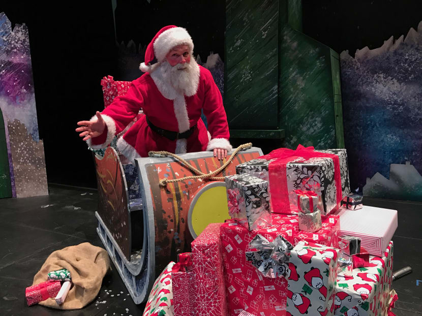Father Christmas posing with his sleigh that is stocked full of presents. Photo: Sonia Yeo/TODAY
