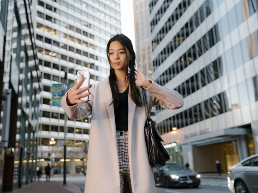 Ms Alison Chen, who has over 25,000 followers on TikTok, makes a video of her work life in San Francisco, Nov 21, 2022.