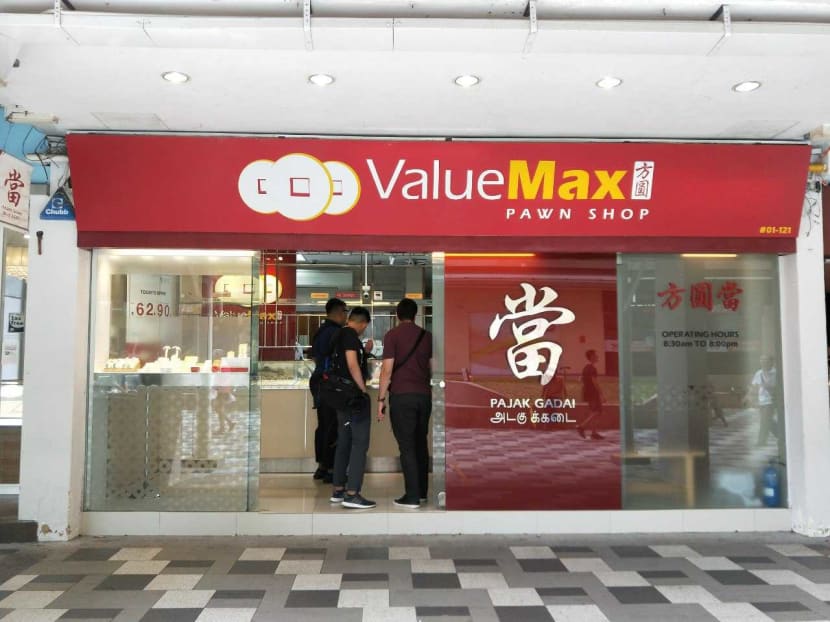 Police attending the scene of an attempted armed robbery at a ValueMax pawn shop in Bedok on Friday.