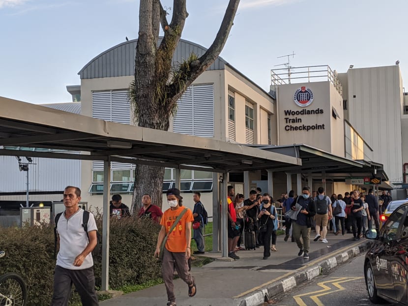 People streaming across the Woodlands Checkpoint into Singapore on March 17, 2020, the morning after Malaysia announced a nationwide lockdown.