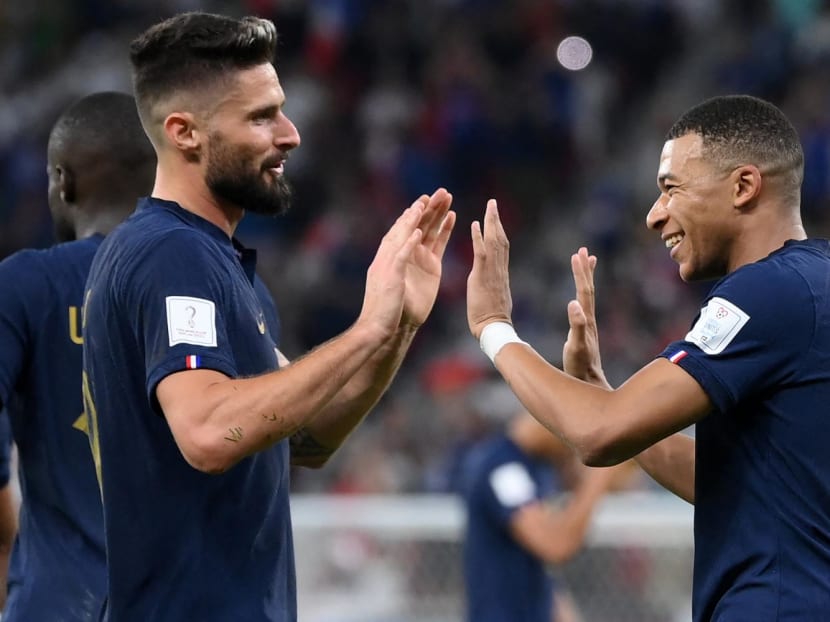 France's forward Kylian Mbappe (right) celebrates scoring his team's second goal with teammate Olivier Giroud during the Qatar 2022 World Cup round of 16 match between France and Poland at the Al-Thumama Stadium in Doha on Dec 4, 2022.