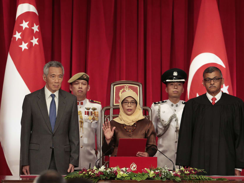 Madam Halimah Yacob, flanked by Prime Minister Lee Hsien Loong and Chief Justice Sundaresh Menon, being sworn in as President of Singapore on Sept 14, 2017.