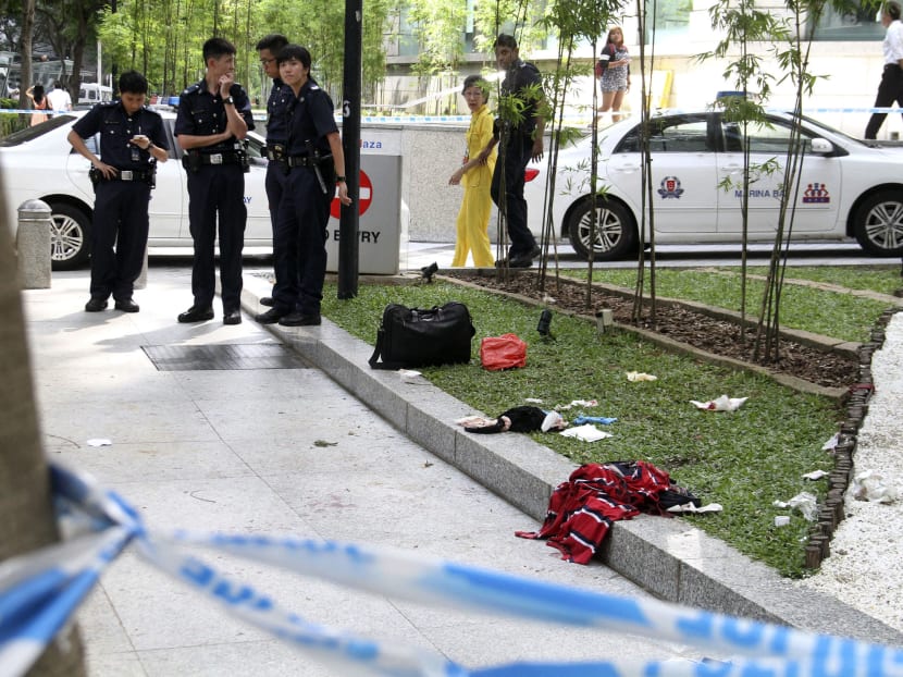 The police cordoned off a part of Raffles Green yesterday after the incident. Drops of blood could be seen on the ground, along with a knife. Photo: Geneive Teo