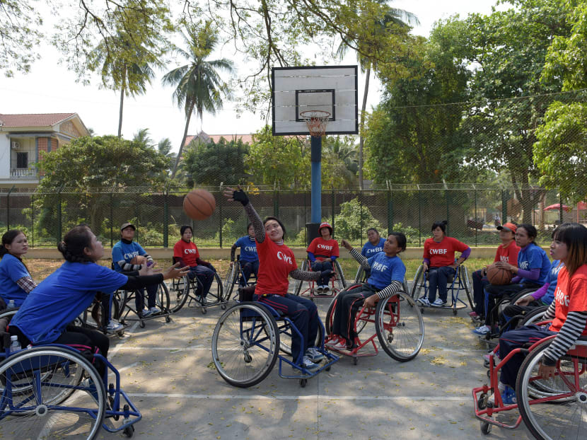 This photo taken on February 18, 2016 shows Sieng Sokchan (centre R), the captain of Cambodia's first women's wheelchair basketball team, working with teammates during a training session at the International Committee of the Red Cross (ICRC) centre in Battambang province.  Photo: AFP