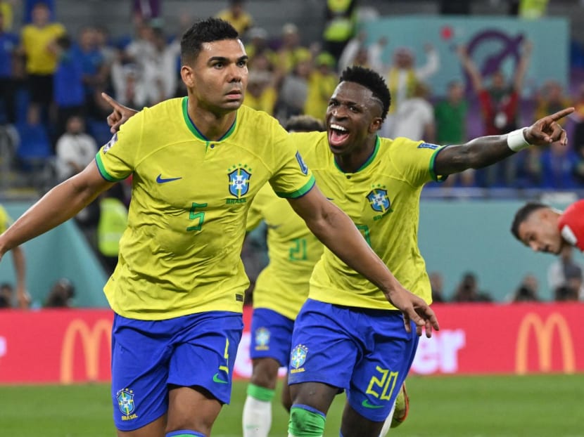 Brazil's Casemiro (left) celebrates with teammate Vinicius Junior after he scored in the Qatar 2022 World Cup Group G football match between Brazil and Switzerland at Stadium 974 in Doha on Nov 28, 2022.