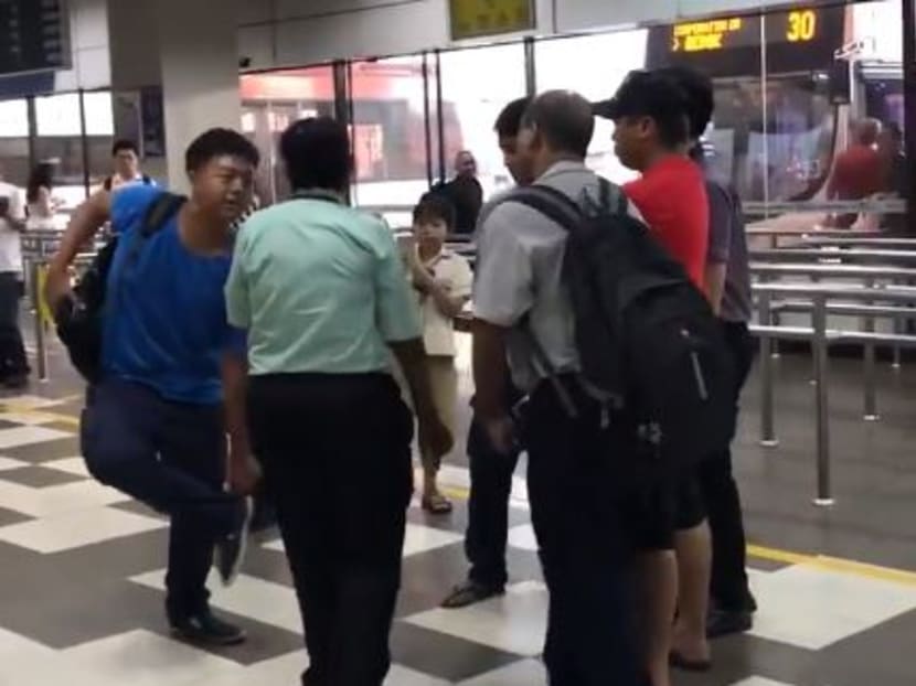 A 17-year-old youth (in blue) who claimed that he was a terrorist with a bomb at a bus interchange was arrested on Wednesday (Aug 23) for causing an act of public nuisance under the Mental Health Act. Photo: Screengrab from video/Social Media