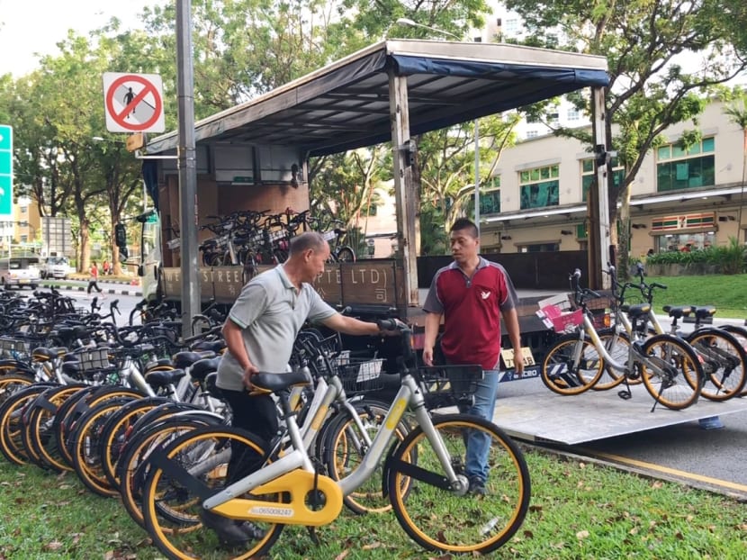 Workers collect oBike bicycles at Choa Chu Kang Avenue 1 on July 4, 2018.
