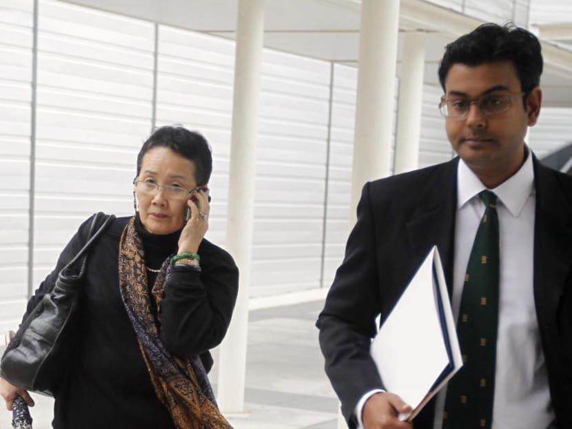 Madam Hedy Mok seen leaving the State Court with her lawyer. TODAY file photo.