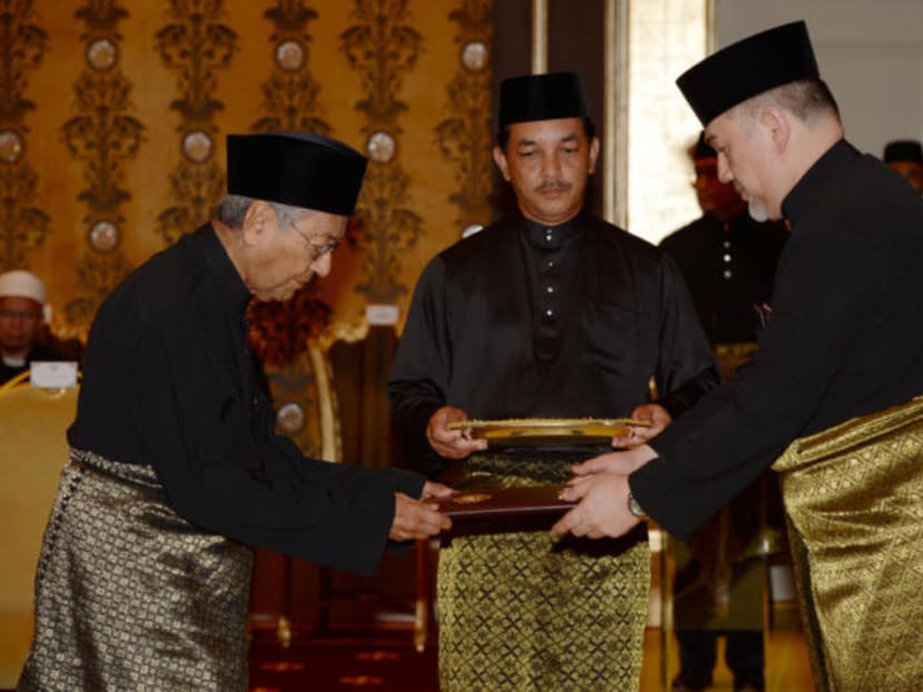 File photo of Dr Mahathir Mohamad being sworn in as Malaysia's seventh prime minister by Sultan Muhammad V at the palace in Kuala Lumpur.