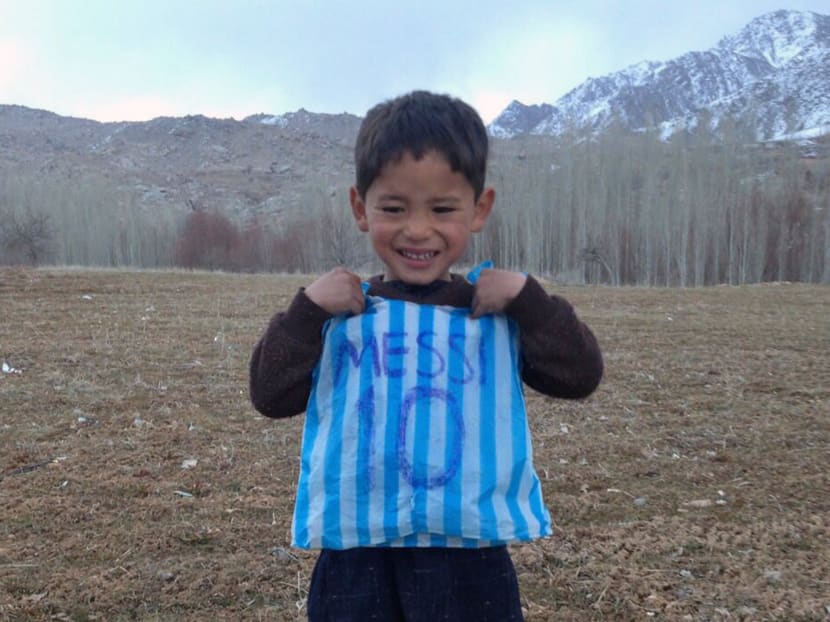 This photograph taken on January 24, 2016 and provided by the family of Afghan boy and Lionel Messi fan Murtaza Ahmadi, 5, with his plastic bag jersey in Jaghori district of Ghazni province. Photo: AFP