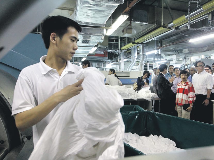 A team from NTUC observing the laundry operations at Sheraton Towers. TODAY file photo.