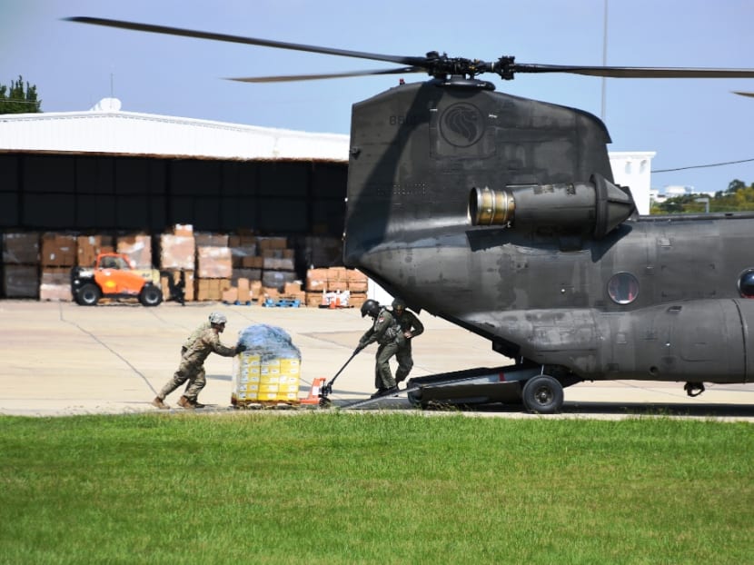 Airmen from the Republic of Singapore Air Force (RSAF) working closely with soldiers from the Texas Army National Guard (TXARNG) to load supplies onto the RSAF's CH-47 Chinook helicopter. (Photo: Mindef)