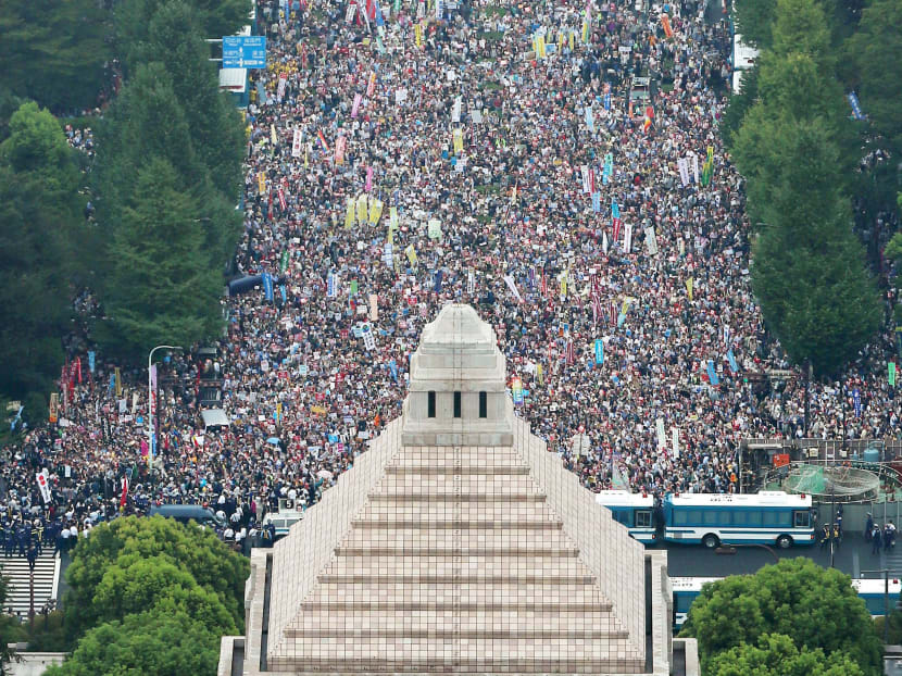 Tens of thousands protest defence bills outside Japan’s parliament