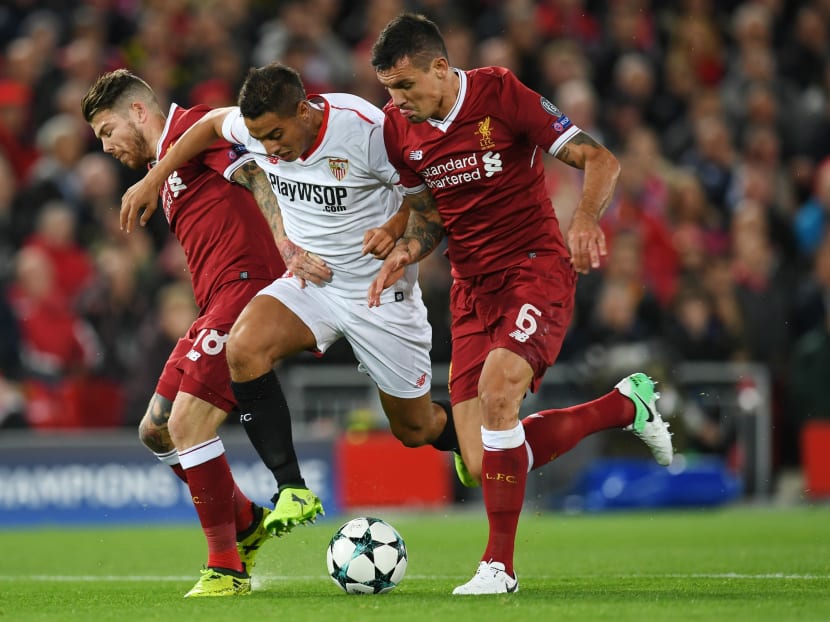 Liverpool defenders Alberto Moreno (left) and Dejan Lovren (right) giving Sevilla's French forward Wissam Ben Yedder the squeeze when the two clubs met in a Champions league group stage clash this week. Photo: AFP