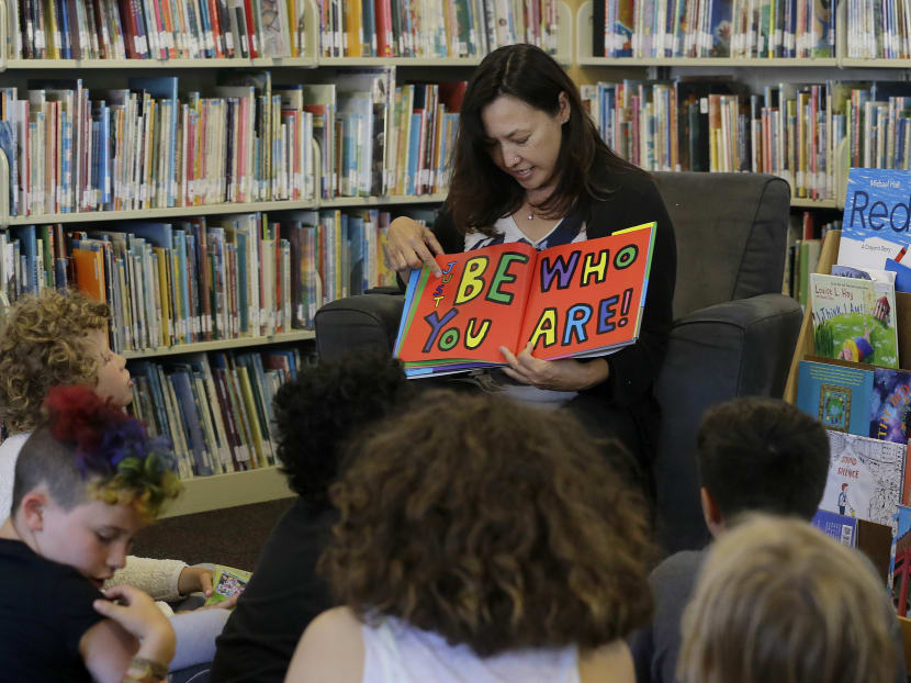 In this Wednesday, July 12, 2017 photo, Ms Sandra Collins, executive director and founder of enGender, reads a book to campers at the Bay Area Rainbow Day Camp in El Cerrito, California. Photo: AP